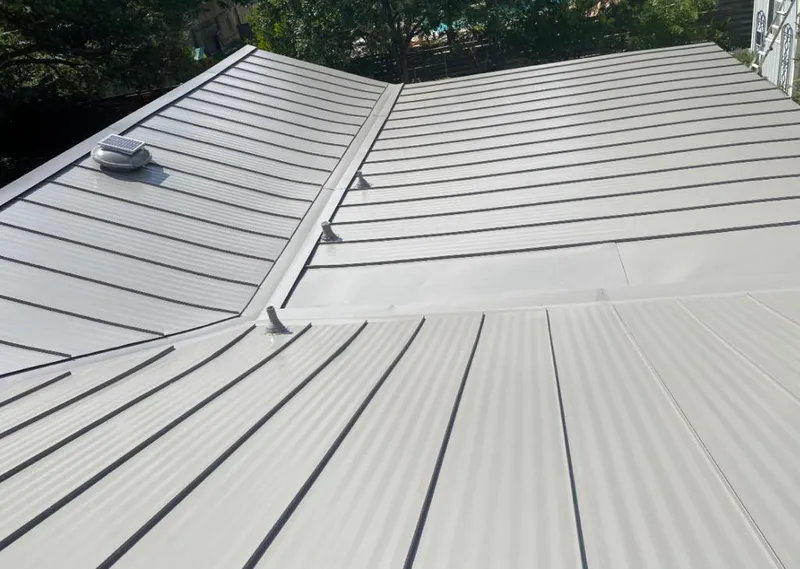 Solar attic fan installed on a metal roof for Roof Ventilation in Fort Lee
